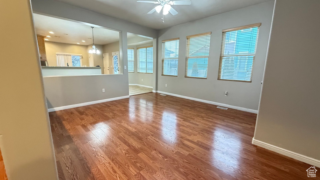 Empty room featuring wood-type flooring and ceiling fan