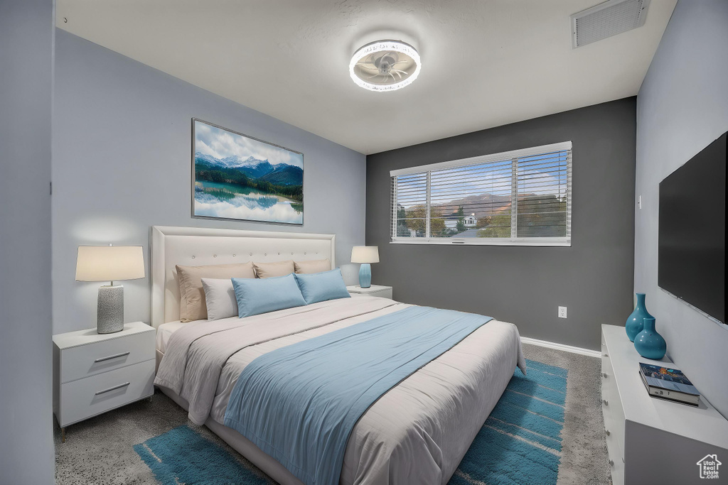 Carpeted bedroom featuring baseboards and visible vents