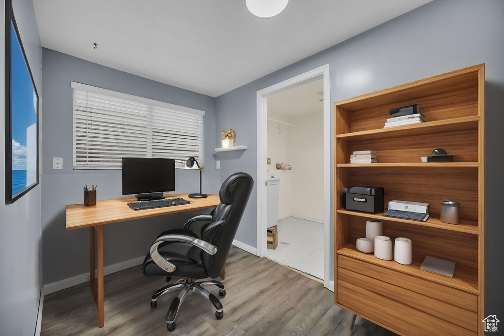 Office space featuring baseboards and wood finished floors