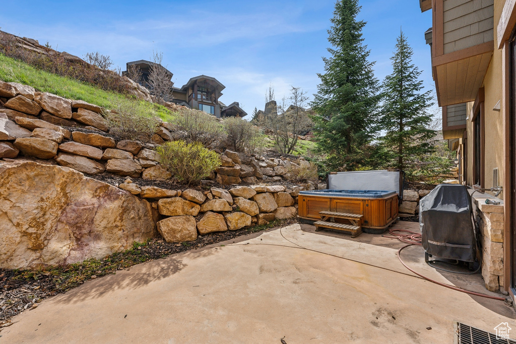 View of patio / terrace with a hot tub and area for grilling
