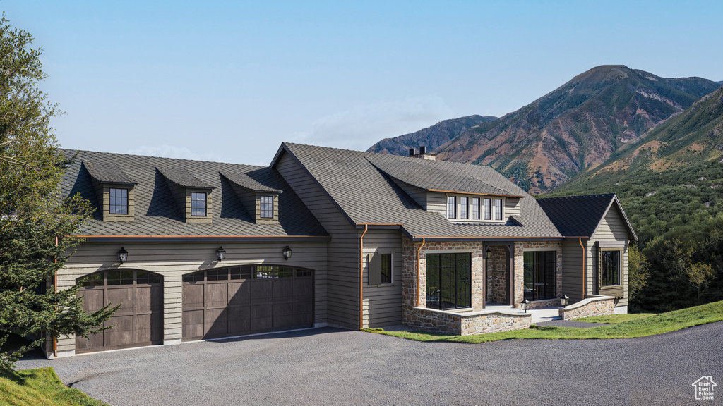 View of front facade featuring a garage and a mountain view