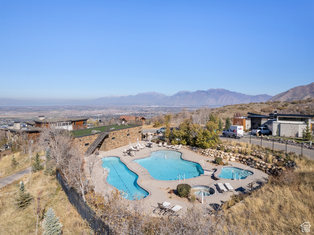 View of swimming pool featuring a mountain view and a patio