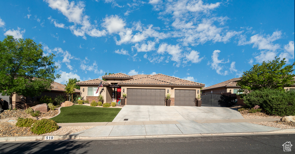 View of front of house with a garage and a front lawn