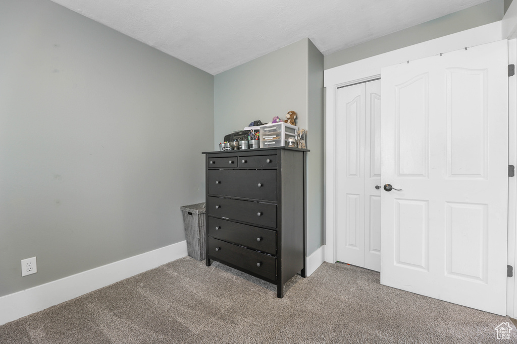 Bedroom with a closet, carpet flooring, and baseboards