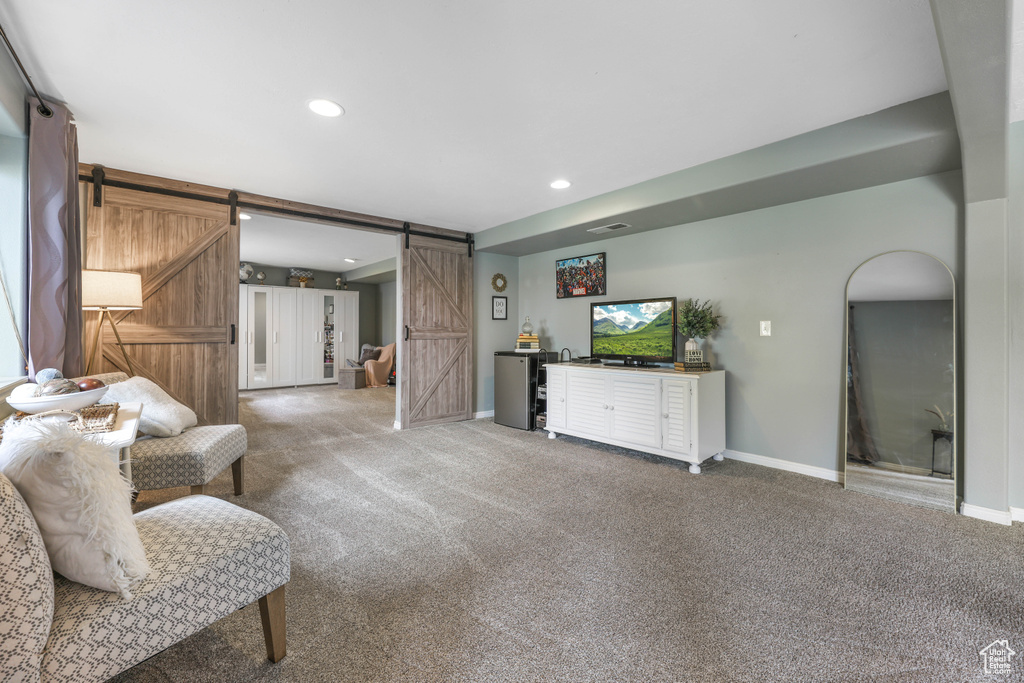 Sitting room with baseboards, carpet, recessed lighting, and a barn door