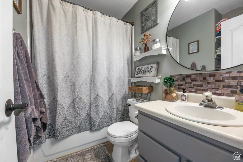 Bathroom with tasteful backsplash, toilet, and vanity