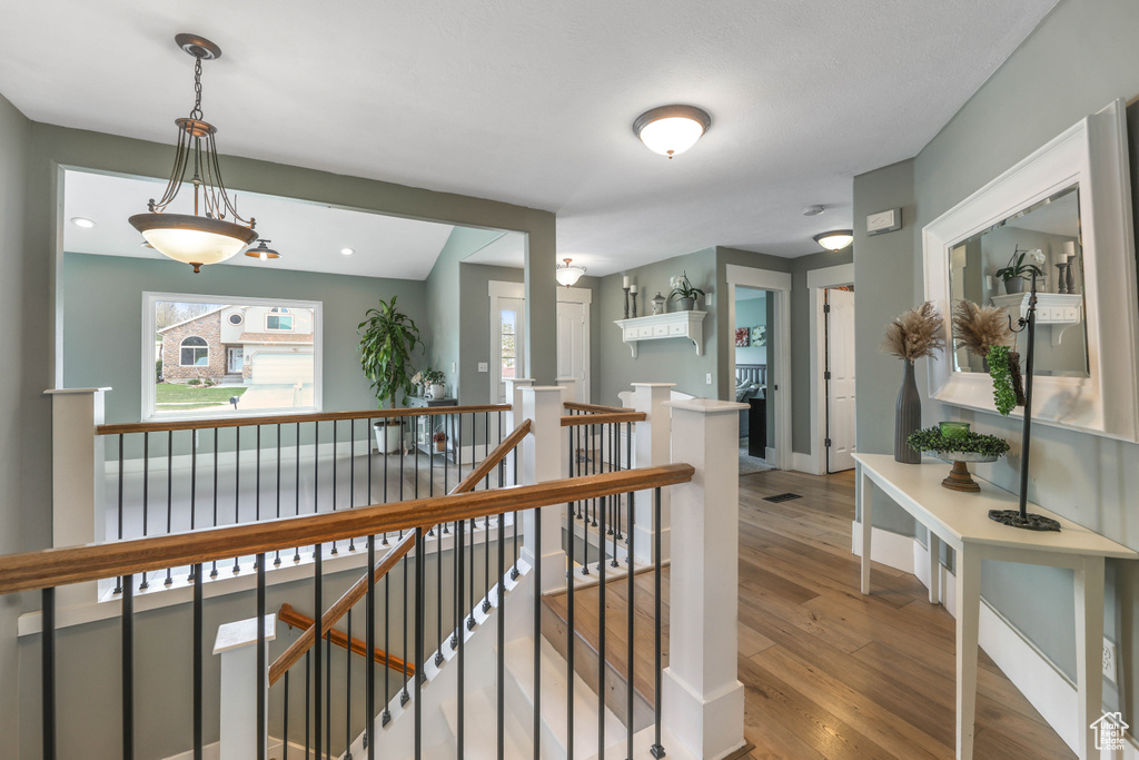 Hall featuring wood finished floors and an upstairs landing