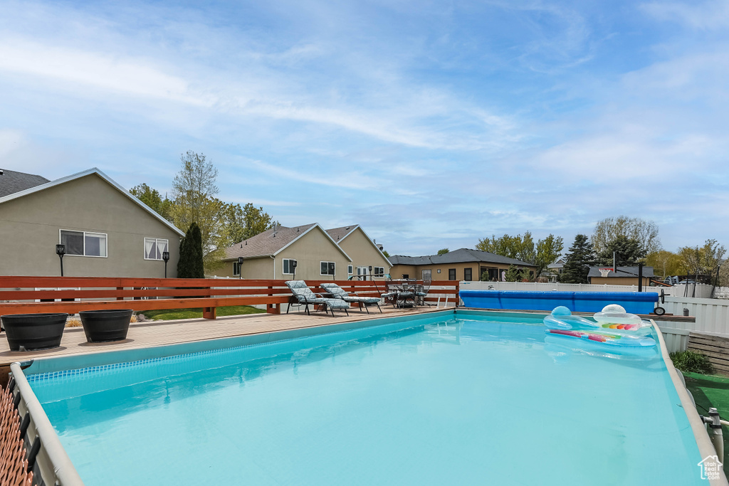 View of pool with fence and a fenced in pool