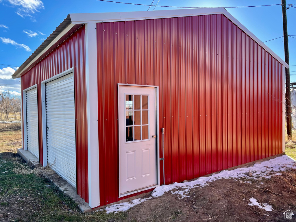 View of outbuilding with a garage