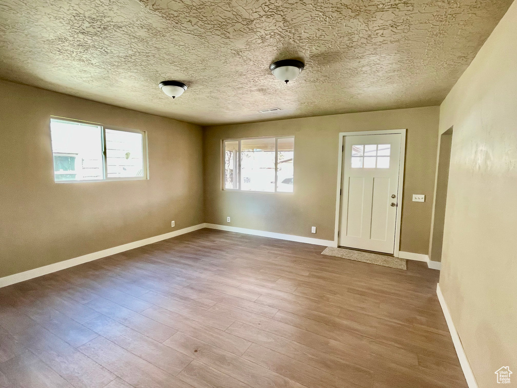 Foyer featuring hardwood / wood-style floors and a textured ceiling