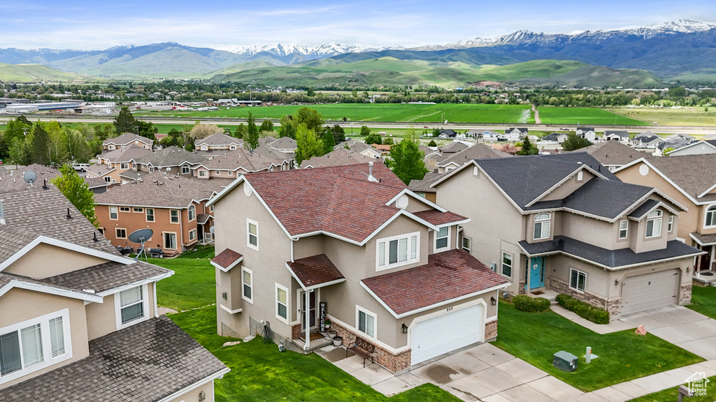Aerial view of residential area featuring a mountainous background