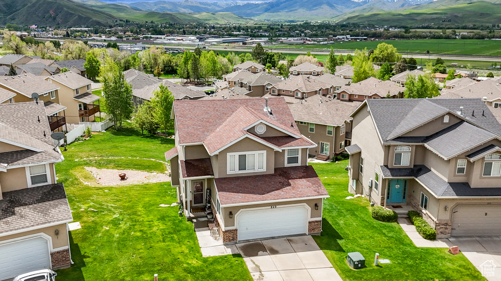 Aerial view of residential area featuring a mountainous background