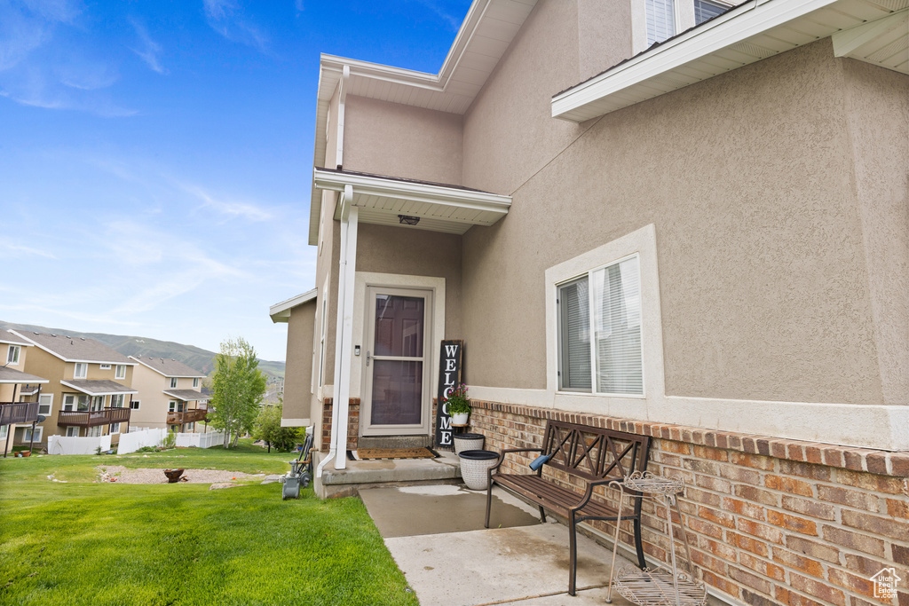View of exterior entry featuring stucco siding and a residential view