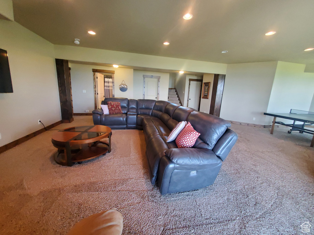 Living area featuring carpet, baseboards, stairs, and recessed lighting