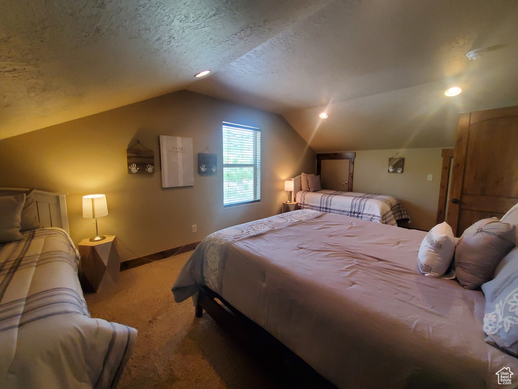 Bedroom with light carpet, lofted ceiling, baseboards, recessed lighting, and a textured ceiling