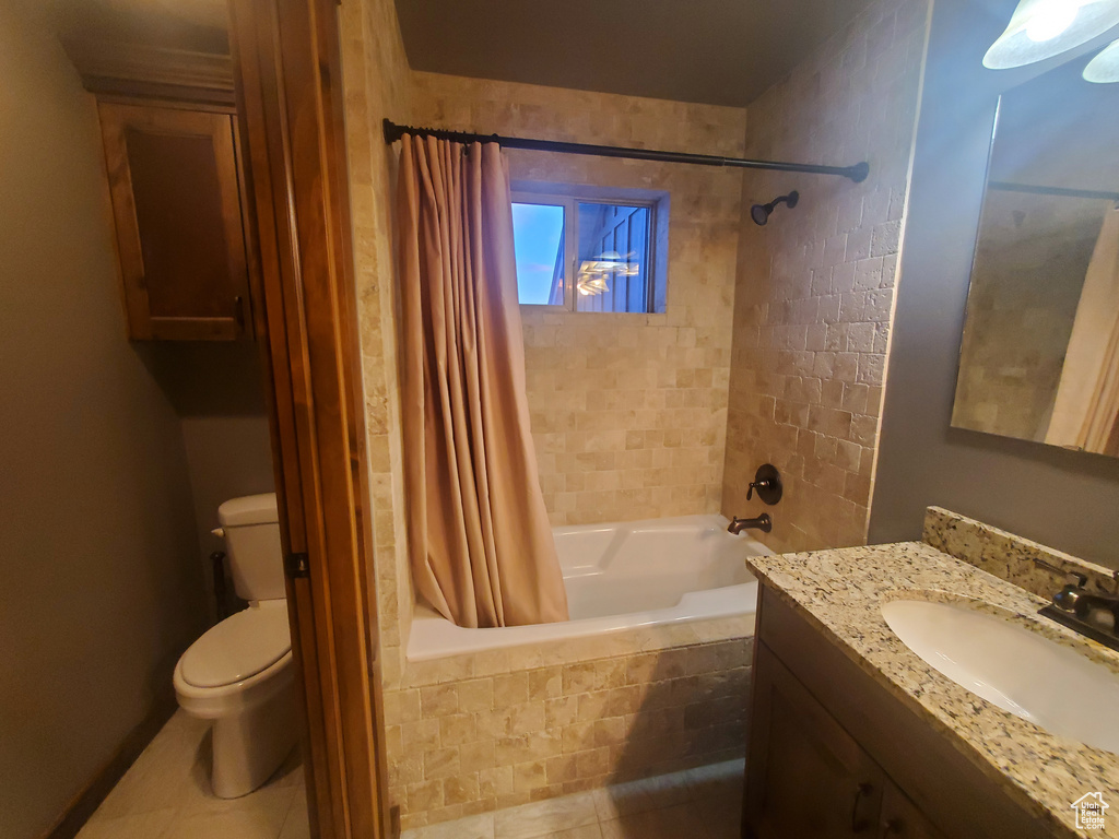 Full bathroom featuring vanity, tile patterned floors, toilet, and shower / bath combo