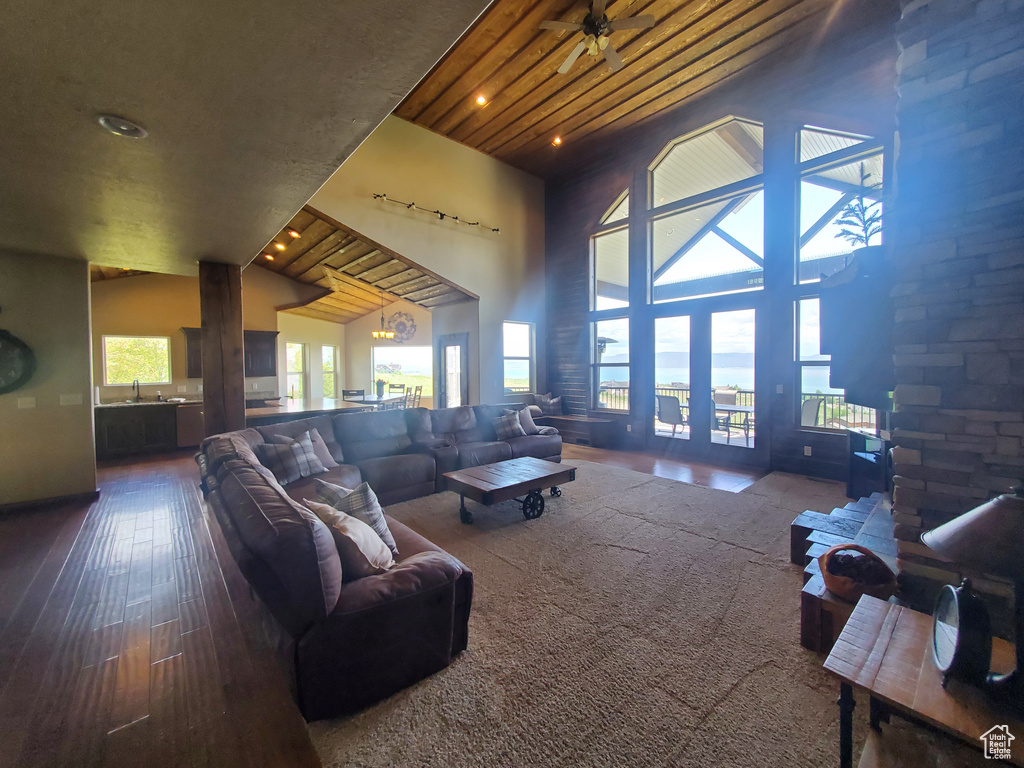 Living area featuring high vaulted ceiling, hardwood / wood-style floors, and recessed lighting