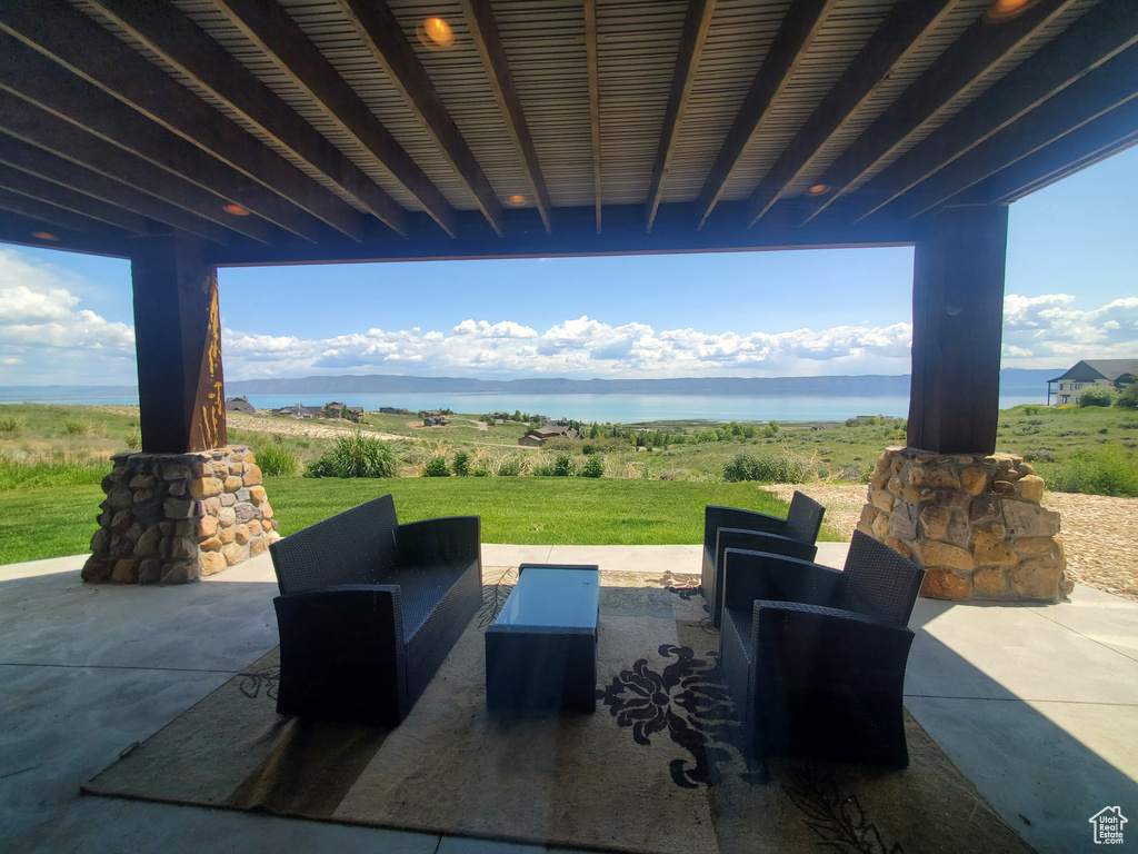 View of patio with outdoor lounge area and a water view