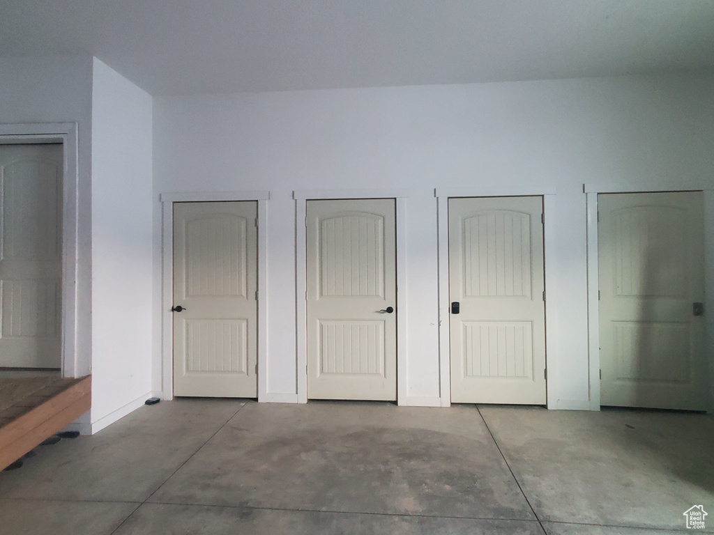 Interior space with two closets and concrete flooring