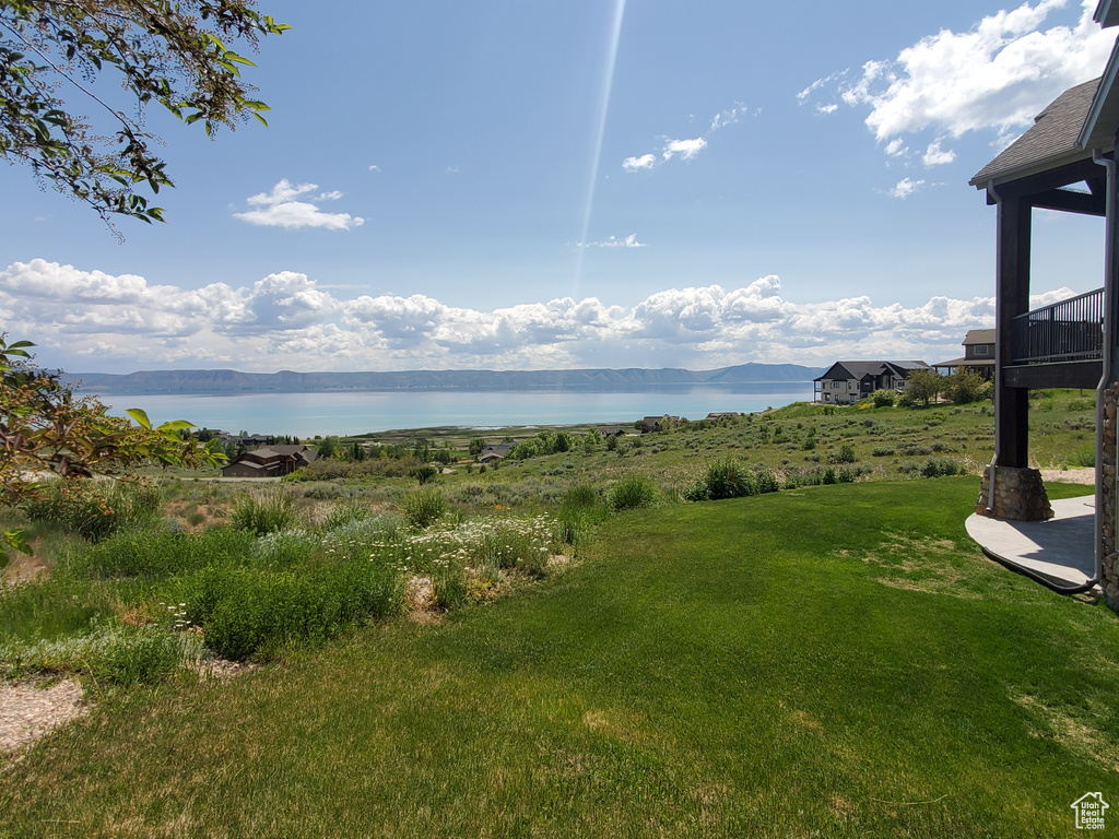 View of grassy yard with a water view