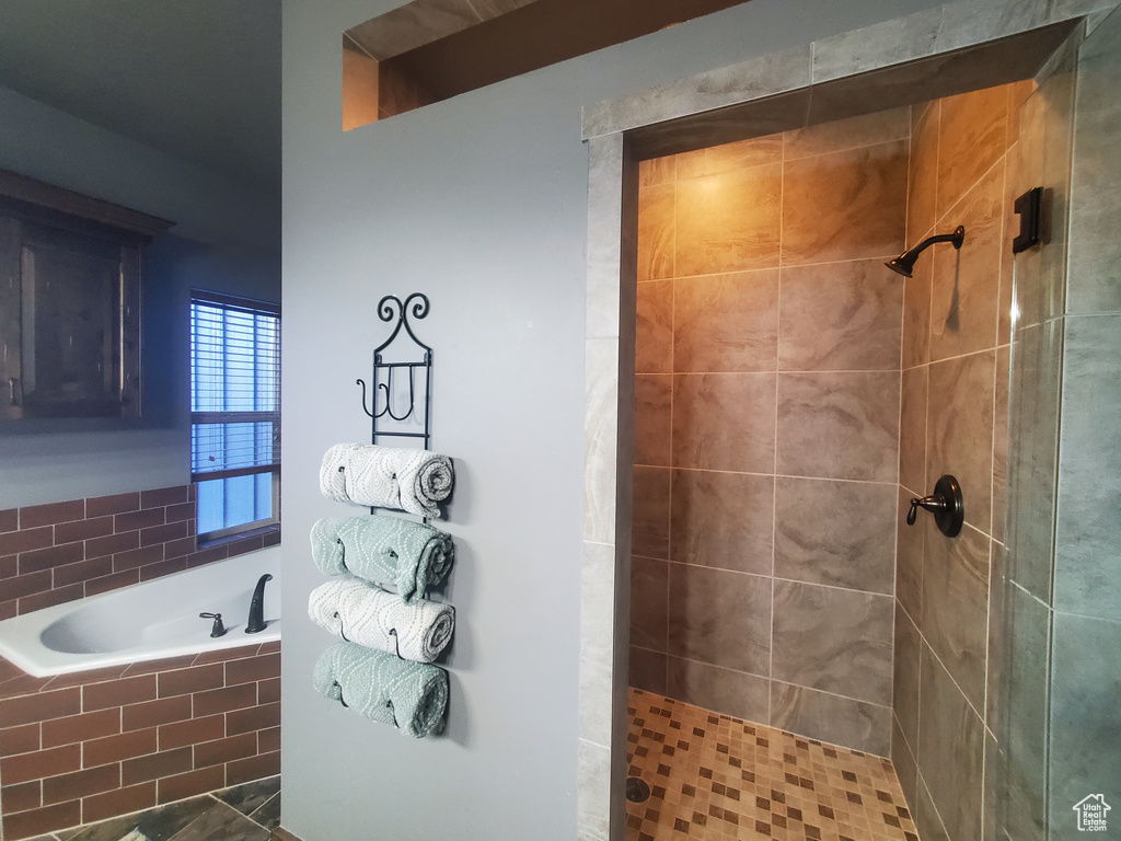 Bathroom featuring plus walk in shower
