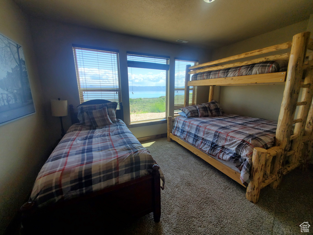 Carpeted bedroom featuring baseboards
