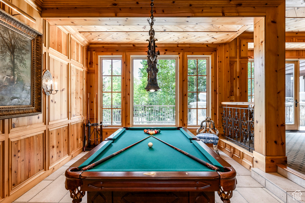 Recreation room featuring wood walls, pool table, tile patterned floors, and wooden ceiling