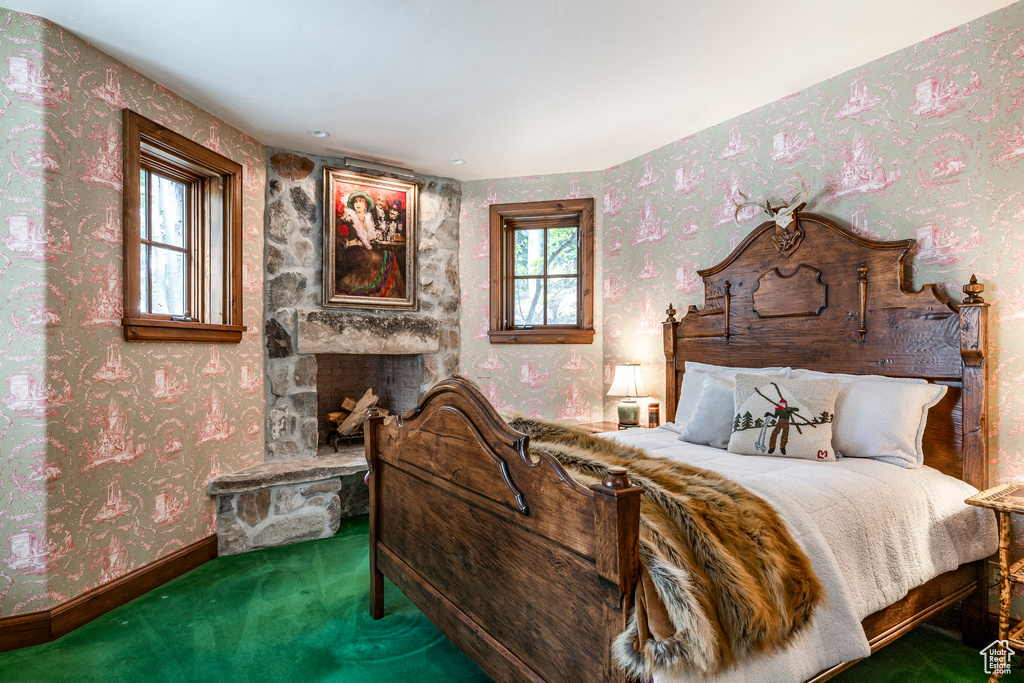 Carpeted bedroom with wallpapered walls