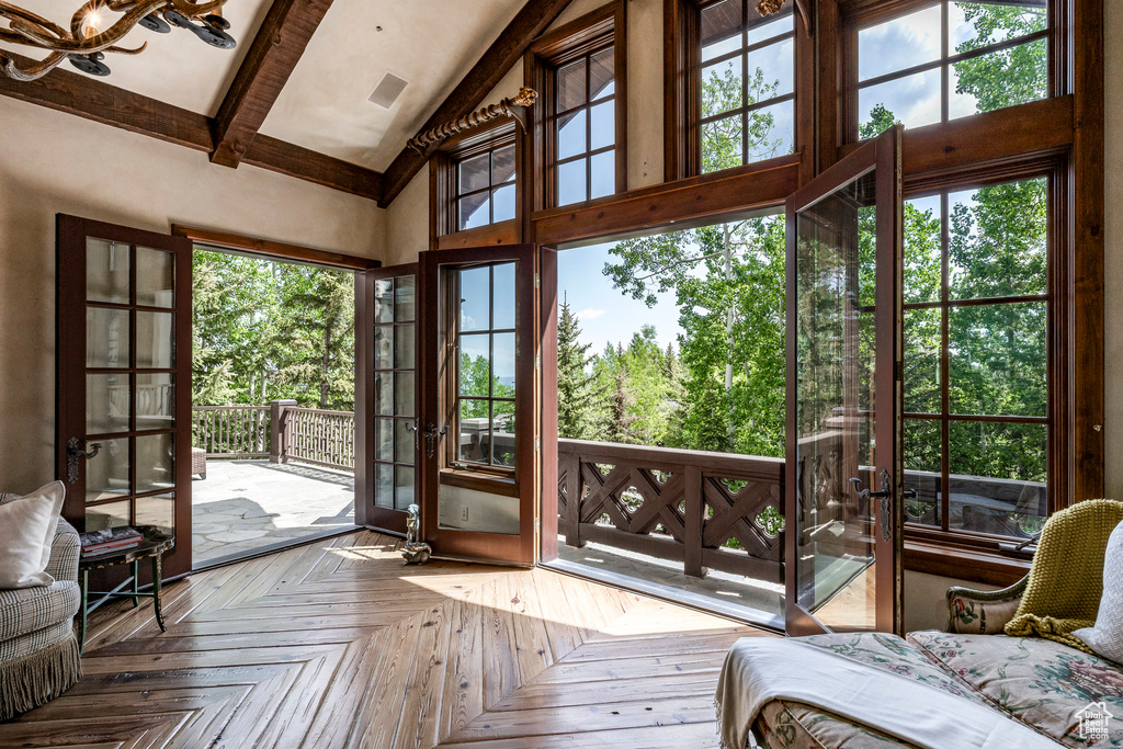 Entryway featuring high vaulted ceiling, beam ceiling, and french doors