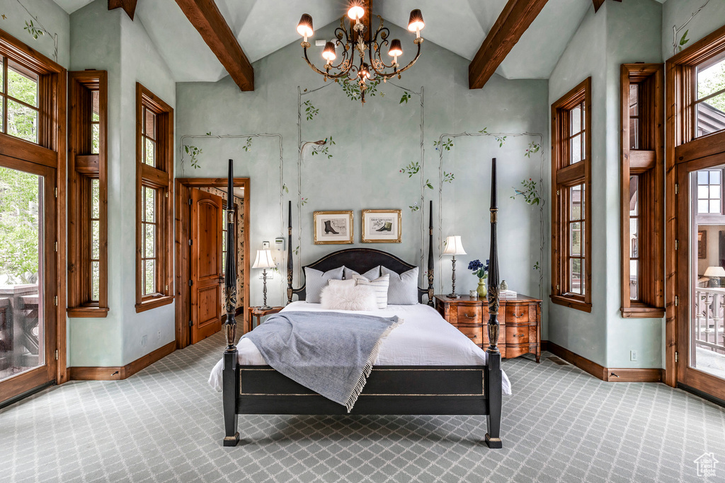 Carpeted bedroom featuring high vaulted ceiling, a chandelier, beamed ceiling, and access to outside
