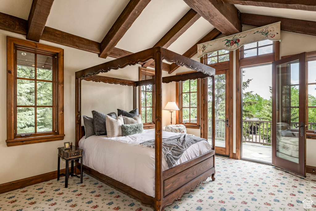 Bedroom with access to outside, multiple windows, and light carpet