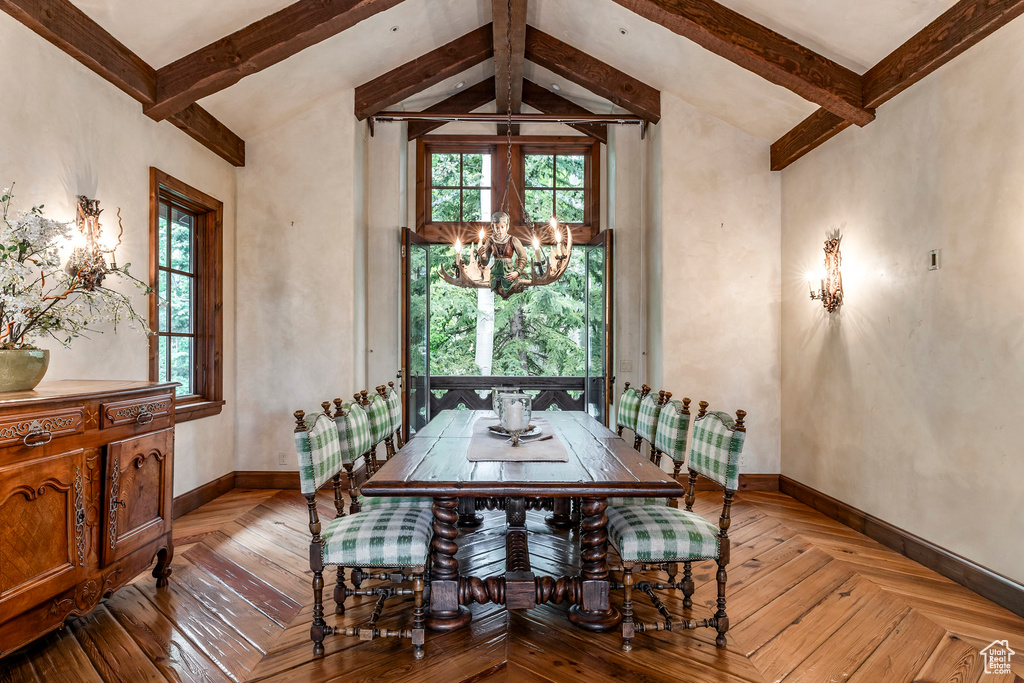 Dining area featuring a chandelier and baseboards
