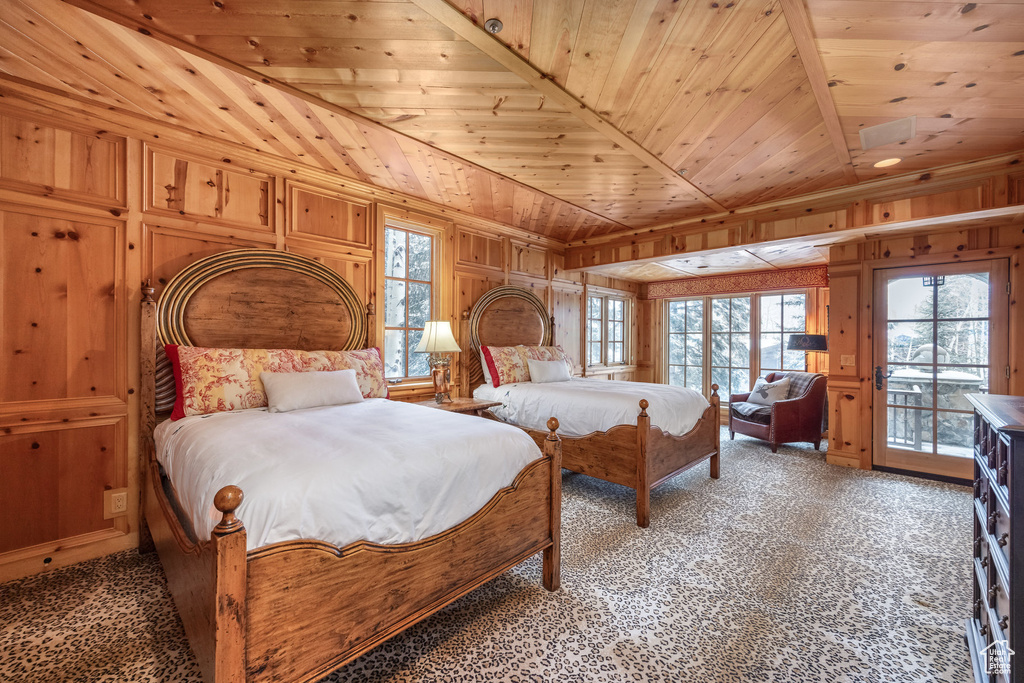Bedroom with access to outside, carpet, wooden ceiling, wood walls, and lofted ceiling