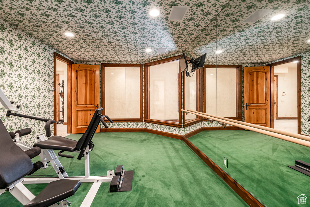Exercise area featuring wallpapered walls, carpet flooring, and recessed lighting