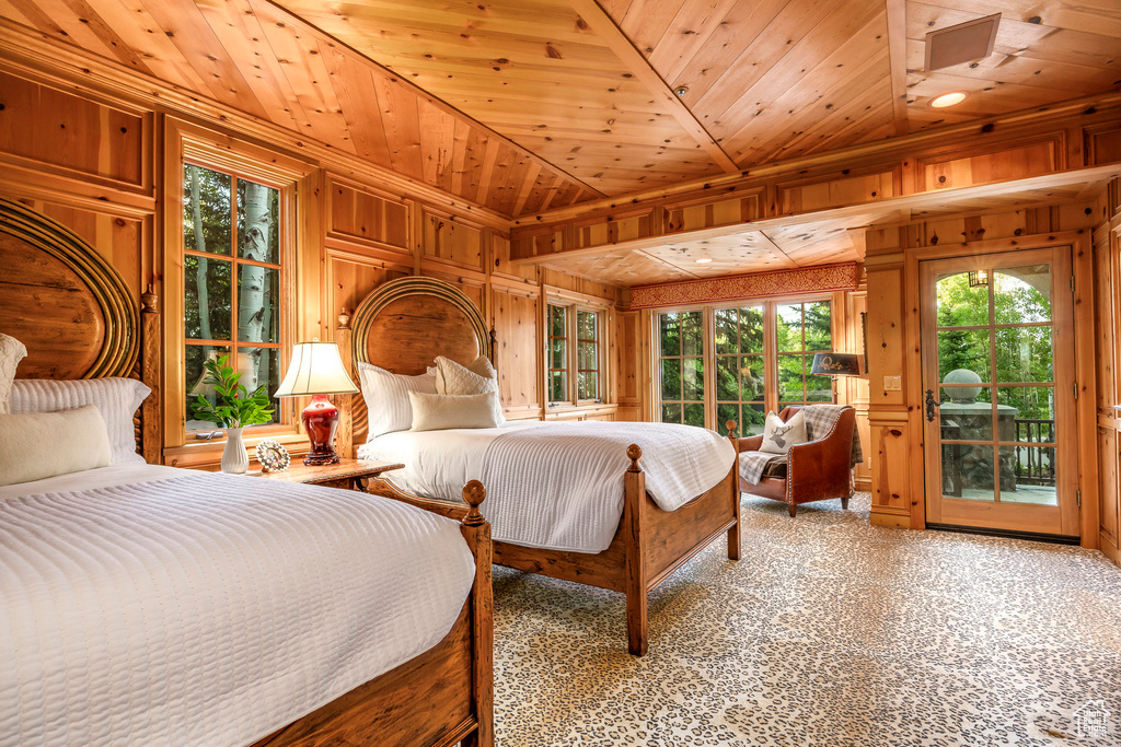 Bedroom featuring wood walls, access to outside, and wood ceiling