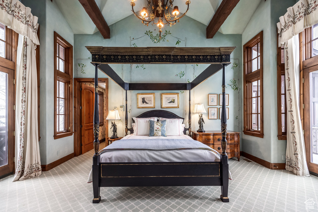 Carpeted bedroom with a chandelier, high vaulted ceiling, and beamed ceiling