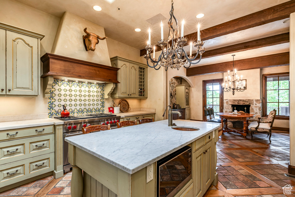 Kitchen with black microwave, a chandelier, luxury range, healthy amount of natural light, and recessed lighting