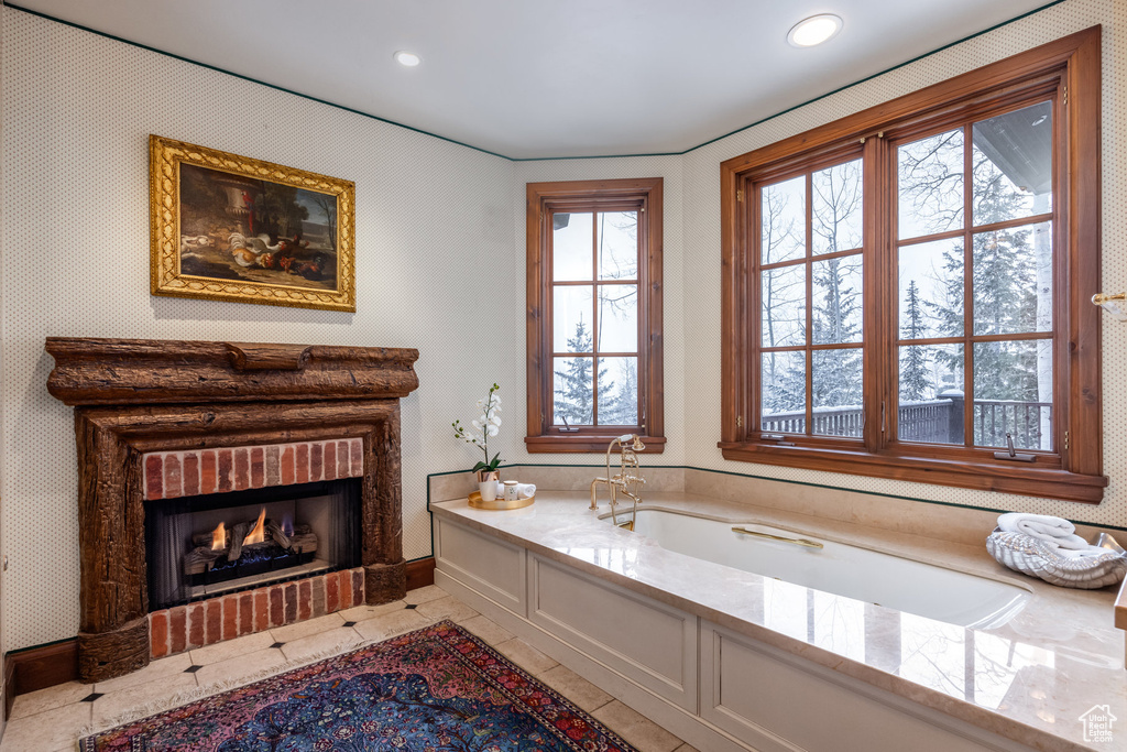 Full bath featuring baseboards, recessed lighting, a fireplace, tile patterned flooring, and a bath