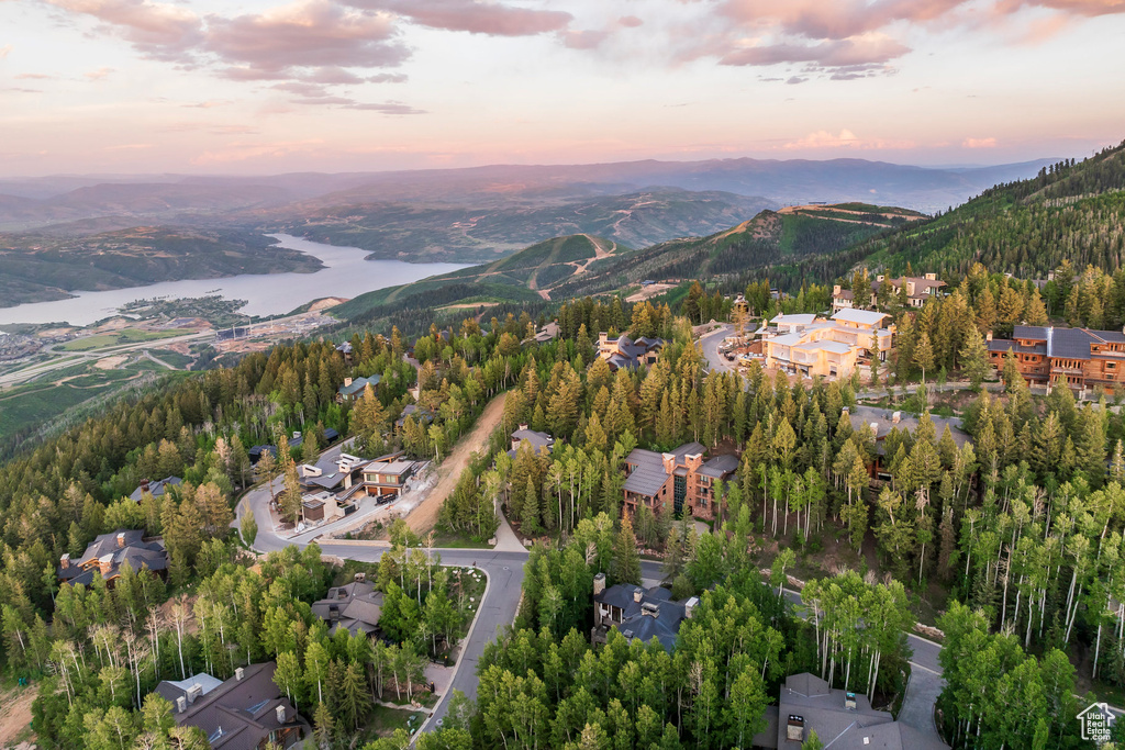 Aerial view of property and surrounding area featuring a mountain backdrop