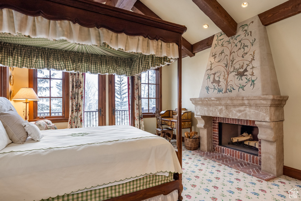 Carpeted bedroom with recessed lighting, a fireplace, and beamed ceiling
