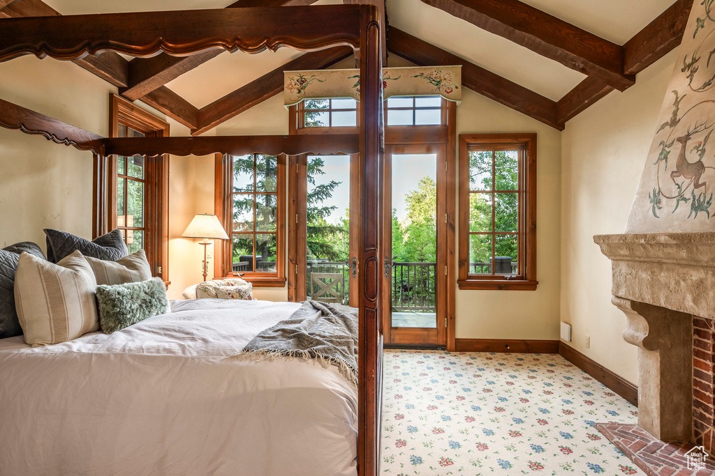 Carpeted bedroom featuring access to exterior and a fireplace