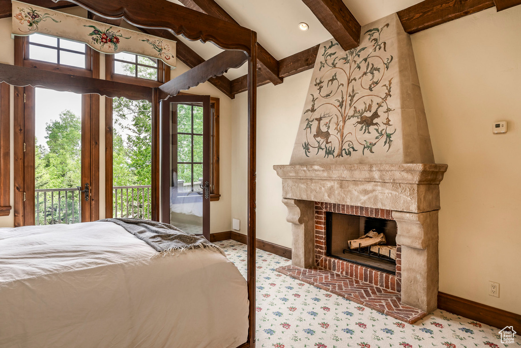 Unfurnished bedroom with access to exterior, a fireplace, and carpet floors
