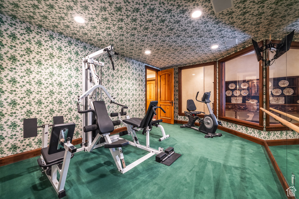 Workout area featuring wallpapered walls and baseboards