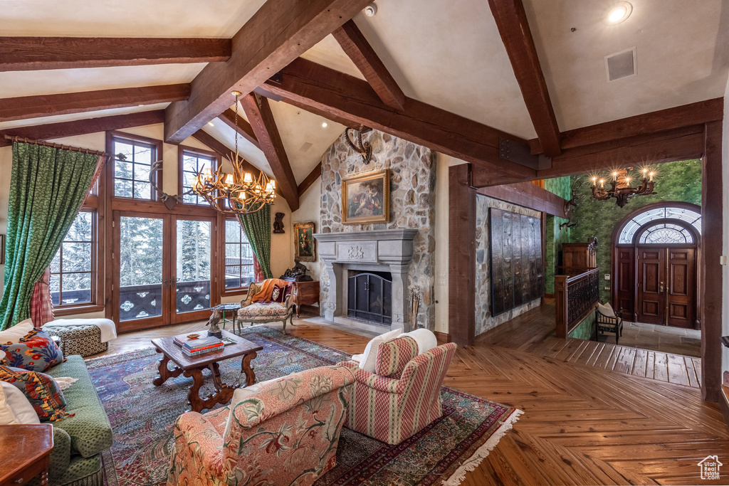 Living area featuring a chandelier, high vaulted ceiling, and beamed ceiling