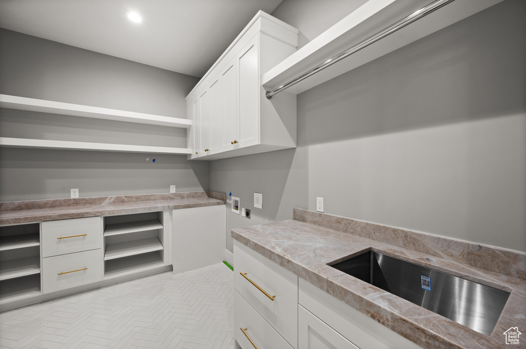 Laundry room featuring washer hookup, cabinet space, and hookup for an electric dryer