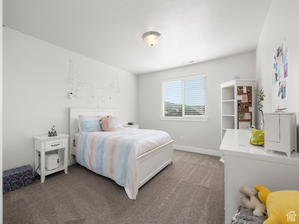 Bedroom featuring light colored carpet