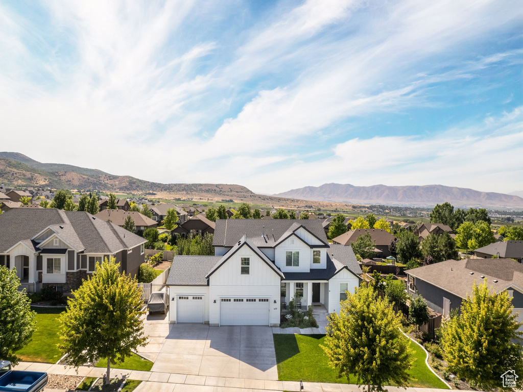 View of front facade featuring a garage and a mountain view