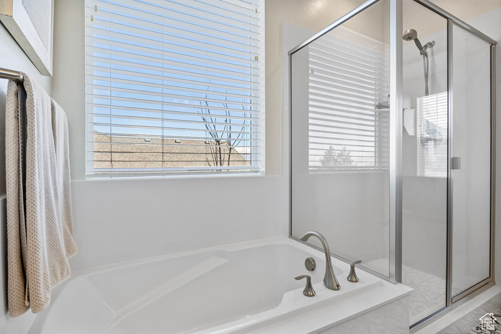 Bathroom with a stall shower and a garden tub