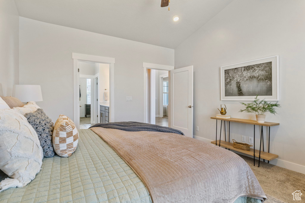 Carpeted bedroom featuring high vaulted ceiling and baseboards