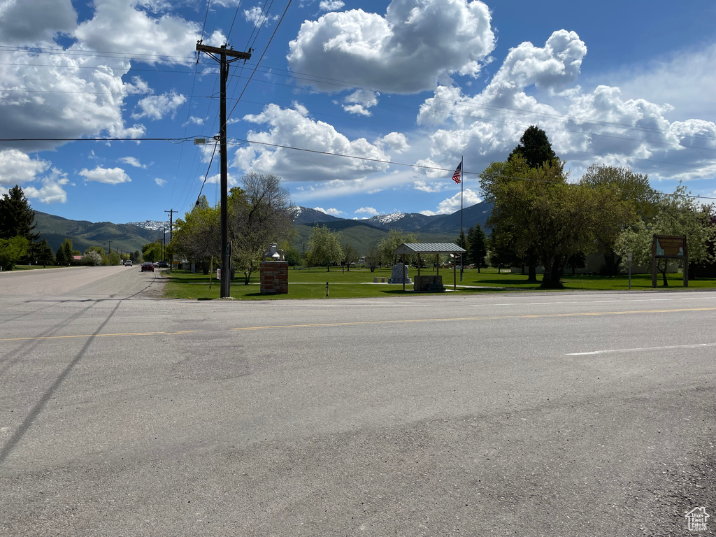 View of asphalt street featuring a mountain view